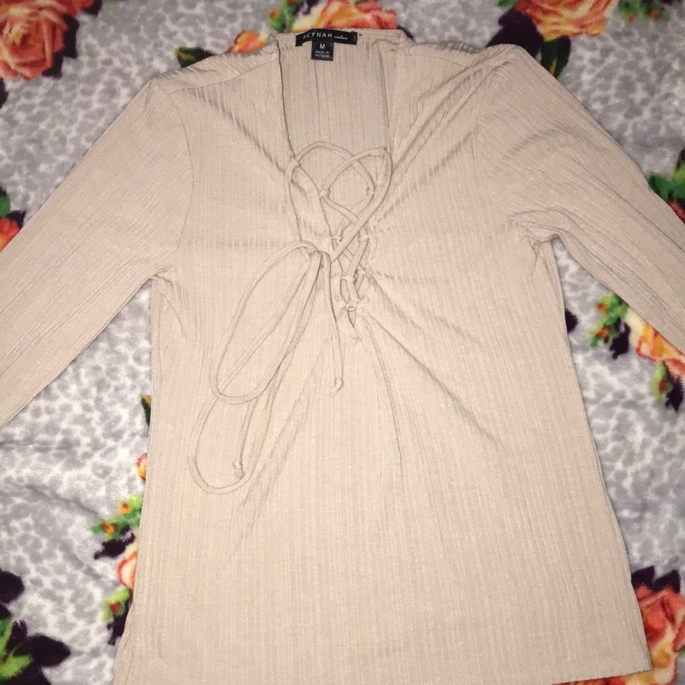 Ripped long sleeve shirt with tie up front.